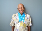 Swimmer John Tatum proudly wears his gold medals from the National Senior Olympics. Swimmer John Tatum proudly wears his gold medals from the National Senior Olympics.