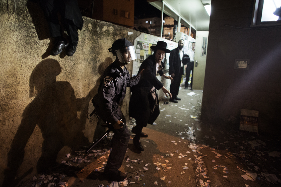 An Israeli police officer arrests an Ultra-Orthodox Jew during a protest against the draft law in Jerusalem on May 16.