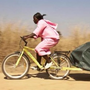 Bike ambulance driver Grace Kakyo transports a patient in northern Uganda.