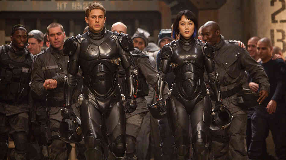 Charlie Hunnam and Rinko Kikuchi are the human co-pilots who mind-meld to control the giant Jaegers — massive robots engineered to fight rampaging sea monsters — in Pacific Rim, a kaiju-film homage from director Guillermo del Toro. Charlie Hunnam and Rinko Kikuchi are the human co-pilots who mind-meld to control the giant Jaegers — massive robots engineered to fight rampaging sea monsters — in Pacific Rim, a kaiju-film homage from director Guillermo del Toro.