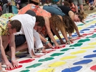Festivalgoers play a giant game of Twister during the Glastonbury Festival of Contemporary Performing Arts in southwest England last month. Festivalgoers play a giant game of Twister during the Glastonbury Festival of Contemporary Performing Arts in southwest England last month.