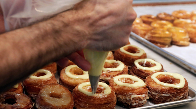 Chef Dominique Ansel makes cronuts, a croissant-donut hybrid, at his New York bakery in June. (AP)