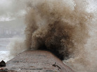 Huge typhoon-driven waves surge up the coastline of Huangqi Peninsula in China's eastern Fujian province on Saturday. Huge typhoon-driven waves surge up the coastline of Huangqi Peninsula in China's eastern Fujian province on Saturday.