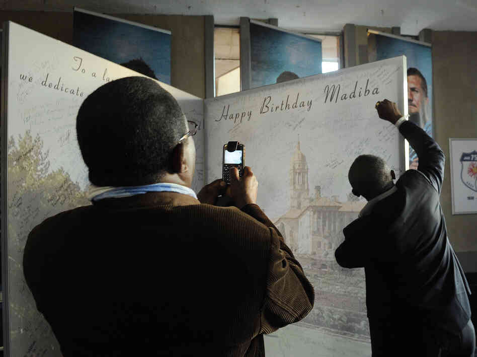 A man signs a large birthday card at Loftus Stadium in Pretoria for ailing former South African President Nelson Mandela's upcoming July 18 birthday. 'Madiba' is Mandela's clan name. A man signs a large birthday card at Loftus Stadium in Pretoria for ailing former South African President Nelson Mandela's upcoming July 18 birthday. 'Madiba' is Mandela's clan name.