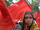 A Bangladeshi garment worker participates in a protest outside the Bangladesh Garment Manufacturers and Export Association office building in the capital, Dhaka, on July 11. The country's Parliament approved a new law that would allow workers to unionize more freely. A Bangladeshi garment worker participates in a protest outside the Bangladesh Garment Manufacturers and Export Association office building in the capital, Dhaka, on July 11. The country's Parliament approved a new law that would allow workers to unionize more freely.