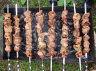 Shashlik cooks on a hot grill. Kakheti, the easternmost province in the Republic of Georgia, is known for meats grilled over grapevines, which burn quickly, leaving a heap of finger-sized coals. Shashlik cooks on a hot grill. Kakheti, the easternmost province in the Republic of Georgia, is known for meats grilled over grapevines, which burn quickly, leaving a heap of finger-sized coals.