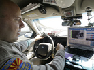 An Arizona Department of Public Safety officer keeps an eye on his dashboard computer as it reads passing car license plates. An Arizona Department of Public Safety officer keeps an eye on his dashboard computer as it reads passing car license plates.