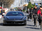 Cyclists look at a Ferrari parked illegally and blocking the bicycle lane off a main road in Beijing, on April 7, 2011. Cyclists look at a Ferrari parked illegally and blocking the bicycle lane off a main road in Beijing, on April 7, 2011.