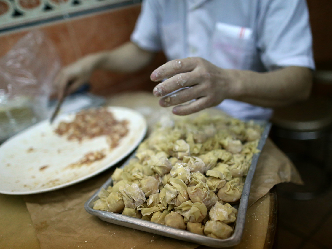 A member of the staff at the one-Michelin-starred restaurant Ho Hung Kee prepares wontons in Hong Kong.