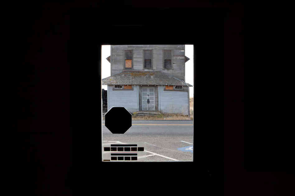 A shuttered granary seen through the door of a rural Oregon post office, which is also slated for closure. A shuttered granary seen through the door of a rural Oregon post office, which is also slated for closure.