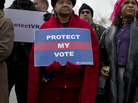 People wait in line outside the Supreme Court in Washington on Feb. 27, 2013, to listen to oral arguments in the Shelby County, Ala., v. Holder voting rights case. In June, the court struck down a key provision of the law that established a formula to identify states that may require extra scrutiny by the Justice Department regarding voting procedures. People wait in line outside the Supreme Court in Washington on Feb. 27, 2013, to listen to oral arguments in the Shelby County, Ala., v. Holder voting rights case. In June, the court struck down a key provision of the law that established a formula to identify states that may require extra scrutiny by the Justice Department regarding voting procedures.