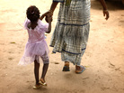 A mother and daughter walk home after attending a community meeting about eradicating female genital mutilation in the western Senegalese village of Diabougo. A mother and daughter walk home after attending a community meeting about eradicating female genital mutilation in the western Senegalese village of Diabougo.