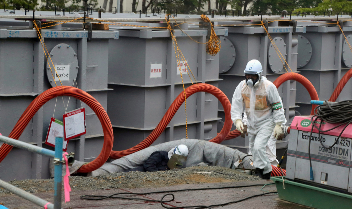 Tokyo Electric Power Co (TEPCO) workers work on waste water tanks at Japan's Fukushima Daiichi nuclear plant in the town of Okuma, Fukushima prefecture in Japan on June 12, 2013.
