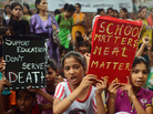 Indian children and activists shout anti-government slogans on Saturday as they march to parliament demonstrating against the death of 23 children in Bihar state after they ate poisoned "midday meals." Indian children and activists shout anti-government slogans on Saturday as they march to parliament demonstrating against the death of 23 children in Bihar state after they ate poisoned "midday meals."