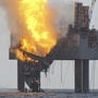 An out-of-control natural gas well in the Gulf of Mexico continued to burn Wednesday after it blew out and caught fire. Beams supporting some of the "Hercules 265 jack-up rig" have collapsed.