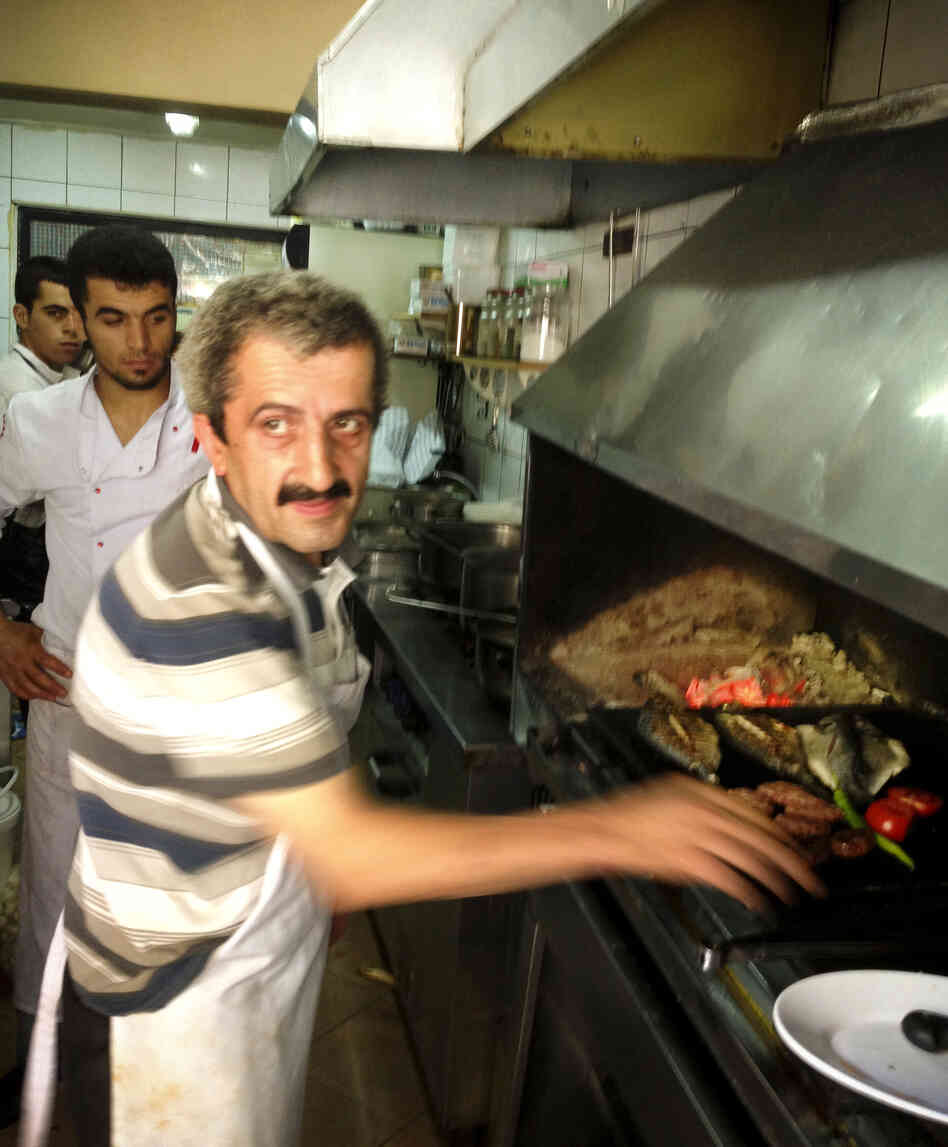 Sabri, a 25-year veteran of the grill, works in the kitchen at Akin Balik restaurant in Istanbul. Sabri, a 25-year veteran of the grill, works in the kitchen at Akin Balik restaurant in Istanbul.