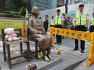 South Korean police stand guard beside a comfort woman statue in front of the Japanese embassy in Seoul in May. The Southern California city of Glendale will dedicate an identical statue on Tuesday. South Korean police stand guard beside a comfort woman statue in front of the Japanese embassy in Seoul in May. The Southern California city of Glendale will dedicate an identical statue on Tuesday.