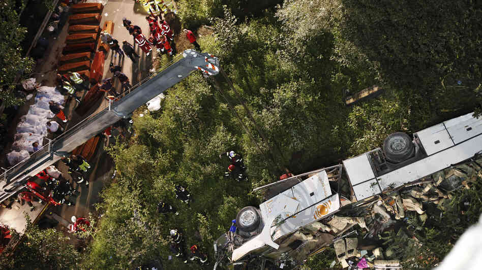 Rescuers prepare coffins for victims of a bus crash in southern Italy. At least 38 people died after a bus plunged off a highway and into a ravine. Rescuers prepare coffins for victims of a bus crash in southern Italy. At least 38 people died after a bus plunged off a highway and into a ravine.