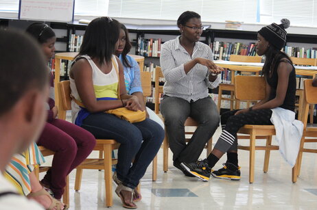 Rose Pierre, the regular classroom teacher who works with the students year round, talks with student Tanavia Thompson at the end of the day. Moses is working with the students on a summer intensive.