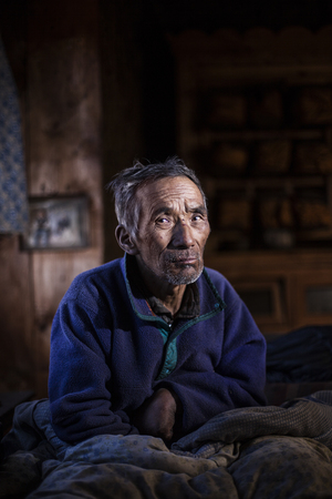 High-altitude stroke victim Lhakpa Gyalzen lives alone in the village of Phortse, Nepal. The region's highest-ranking holy man told him to read 100,000 pages of Buddhist script to heal himself.