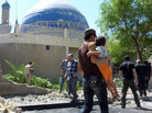Iraqis walk past a wall that a car bomb destroyed, next to the Ahl al-Bayya' mosque in southeastern Baghdad Monday. At least 10 bombings were reported in the city today. Iraqis walk past a wall that a car bomb destroyed, next to the Ahl al-Bayya' mosque in southeastern Baghdad Monday. At least 10 bombings were reported in the city today.