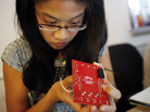 Joyce Yu-Jean Lee, 33, concentrates on a yellow blinking light during a microprocessor workshop with HacDC. Joyce Yu-Jean Lee, 33, concentrates on a yellow blinking light during a microprocessor workshop with HacDC.