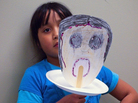 Laura Molina, 9, shows the mask she created expressing the feeling of "sadness." Her mother is being treated for breast cancer at the Lyndon B. Johnson public hospital in Houston. Laura Molina, 9, shows the mask she created expressing the feeling of "sadness." Her mother is being treated for breast cancer at the Lyndon B. Johnson public hospital in Houston.