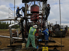 Roughnecks build a drilling rig at the MEG Energy site near Fort McMurray, Alberta, Canada. In addition to large, open-pit mining operations, tar sands oil can be extracted from the ground by pumping down high-pressure steam. Roughnecks build a drilling rig at the MEG Energy site near Fort McMurray, Alberta, Canada. In addition to large, open-pit mining operations, tar sands oil can be extracted from the ground by pumping down high-pressure steam.