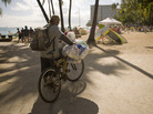 A homeless man collects cans on Waikiki Beach in 2010 in Honolulu. Under a new pilot program, some homeless people will get help from the state to reunite with relatives on the mainland. A homeless man collects cans on Waikiki Beach in 2010 in Honolulu. Under a new pilot program, some homeless people will get help from the state to reunite with relatives on the mainland.