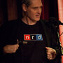 Puzzle guru John Chaneski rocks his famous "nrd" shirt at the World Science Festival taping of Ask Me Another at The Bell House in Brooklyn. Puzzle guru John Chaneski rocks his famous "nrd" shirt at the World Science Festival taping of Ask Me Another at The Bell House in Brooklyn.