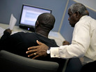 Employment Specialist Louis Holliday, right, helps an applicant file for unemployment at a Georgia Department of Labor career center last month in Atlanta. The jobless rate for African-Americans fell from 13.7 to 12.6 percent in July, but that's still twice the rate for whites. Employment Specialist Louis Holliday, right, helps an applicant file for unemployment at a Georgia Department of Labor career center last month in Atlanta. The jobless rate for African-Americans fell from 13.7 to 12.6 percent in July, but that's still twice the rate for whites.