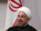 Iran's new President Hassan Rowhani sits next to the national flag on his first official day in office in Tehran on Saturday. Iran's new President Hassan Rowhani sits next to the national flag on his first official day in office in Tehran on Saturday.