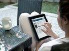 A woman uses a tablet computer. A woman uses a tablet computer.