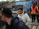 Migrant workers follow a police officer during a raid by Russian immigration authorities at a construction site in Moscow, in 2012. Migrant workers follow a police officer during a raid by Russian immigration authorities at a construction site in Moscow, in 2012.