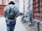 Rear view of a young guy walking down a city street. Rear view of a young guy walking down a city street.