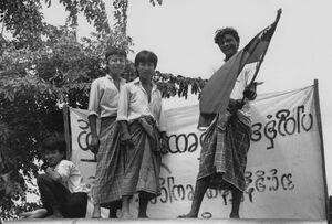 Democracy demonstrators wave the Burmese flag in August 1988, when millions of Burmese took to the streets. Students led the protests, but were soon joined by civil servants, police, soldiers and ordinary citizens. Democracy demonstrators wave the Burmese flag in August 1988, when millions of Burmese took to the streets. Students led the protests, but were soon joined by civil servants, police, soldiers and ordinary citizens.