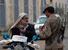 A Yemeni soldier speaks with a motorcyclist amid tightened security near Sanaa International Airport on Tuesday. A Yemeni soldier speaks with a motorcyclist amid tightened security near Sanaa International Airport on Tuesday.