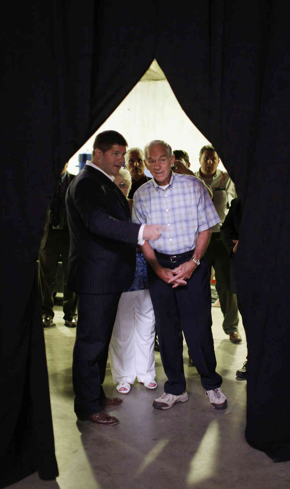 Jesse Benton, left, talks with then-Republican presidential candidate Rep. Ron Paul, R-Texas, in Ames, Iowa, on Aug. 13, 2011. Benton is now campaign manager for Sen. Mitch McConnell, R-Ky. Jesse Benton, left, talks with then-Republican presidential candidate Rep. Ron Paul, R-Texas, in Ames, Iowa, on Aug. 13, 2011. Benton is now campaign manager for Sen. Mitch McConnell, R-Ky.