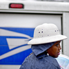 U.S. Postal Service letter carrier Jamesa Euler delivers mail in the rain in Atlanta in February. U.S. Postal Service letter carrier Jamesa Euler delivers mail in the rain in Atlanta in February.
