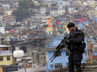 A police officer patrols the rooftop of a school at the Rocinha slum in Rio de Janeiro, Brazil, on Sept. 20, 2012, where a "pacification" anti-crime effort was underway. Rio police are now going to attempt a similar pacification in another huge slum, Mare. A police officer patrols the rooftop of a school at the Rocinha slum in Rio de Janeiro, Brazil, on Sept. 20, 2012, where a "pacification" anti-crime effort was underway. Rio police are now going to attempt a similar pacification in another huge slum, Mare.