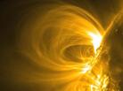 Bright charged particles spin along magnetic field lines above the surface of the sun in the image captured by NASA's Solar Dynamics Observatory. Solar flares like this one shoot high energy protons and radiation into the solar system. Bright charged particles spin along magnetic field lines above the surface of the sun in the image captured by NASA's Solar Dynamics Observatory. Solar flares like this one shoot high energy protons and radiation into the solar system.