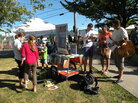 Farmers market visitors browse the offerings of Seattle Public Library's "Books on Bikes" program. Farmers market visitors browse the offerings of Seattle Public Library's "Books on Bikes" program.