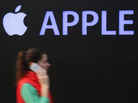 A woman talks on an iPhone as she walks past construction of a new Apple store in Berlin in April. A woman talks on an iPhone as she walks past construction of a new Apple store in Berlin in April.