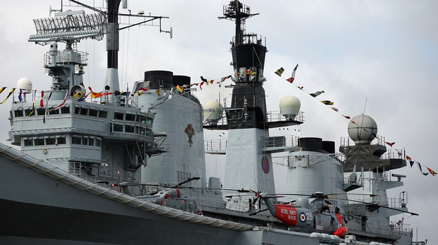 A Sea King helicopter rests on the flight deck of the HMS Illustrious in London.