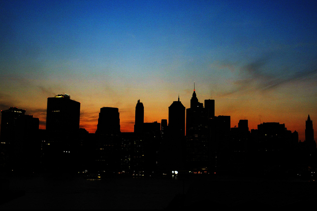 The sun sets over the Manhattan skyline during a major power outage affecting a large part of the Northeastern United States and Canada on Aug. 14, 2003. Ten years later, some improvements have been made to the grid to prevent another large-scale blackout. (Image credit: Getty Images)