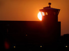 The sun sets behind a guard tower at the federal prison in Terre Haute, Ind. The sun sets behind a guard tower at the federal prison in Terre Haute, Ind.