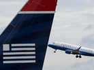 A United Airlines jet takes off behind a US Airways jet at Ronald Reagan Washington National Airport on Tuesday. A United Airlines jet takes off behind a US Airways jet at Ronald Reagan Washington National Airport on Tuesday.