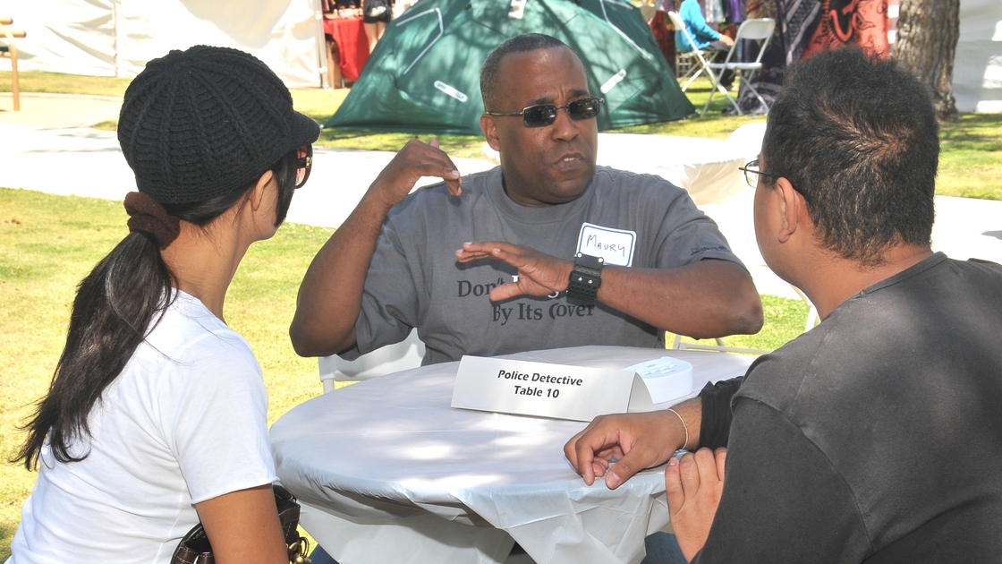 At a Human Library event at the Santa Monica Public Library, a police detective "book" talks to two "readers." Human Library events and projects, which are held at libraries across the country, allow participants to "check out" volunteers and have conversations about their life experiences. At a Human Library event at the Santa Monica Public Library, a police detective "book" talks to two "readers." Human Library events and projects, which are held at libraries across the country, allow participants to "check out" volunteers and have conversations about their life experiences.