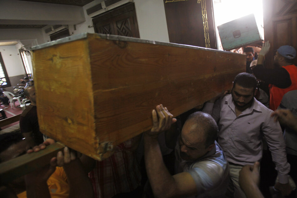 Members of the Muslim Brotherhood carry the coffin of a fellow member at the El-Iman mosque. The Muslim Brotherhood has vowed to continue their protests over Morsi's removal.