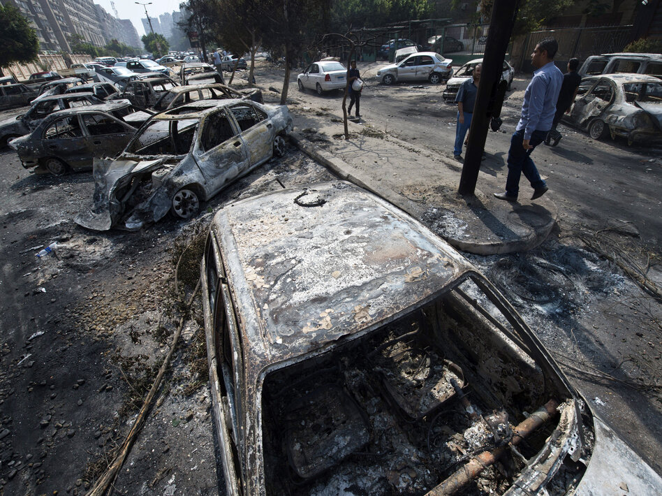 The destroyed camp of Morsi supporters outside the Rabaa al-Adawiya mosque. The raids prompted the military-backed interim leaders to impose a state of emergency and curfew, and drew widespread condemnation from around the world.